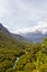 Landscapes of the South Island. Fiordland National Park. View of the snow-capped mountains, dense forest and the river below. New