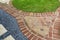 Landscaping detail - red brick path with mosaic flowers - garden/backyard design