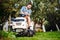 Landscaping details - professional gardener smiling and mowing lawn