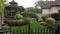 Landscaping image with gazebo and iron fence