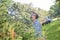 landscaping worker cutting shrub