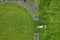 Landscaping Worker Trimming Backyard Grass Using Electric Mower