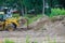 Landscaping works on the bulldozer moves soil digging ground construction