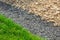 Landscaping yard with rows of stones scattered.