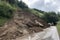 landslide blocking a road, forcing drivers to find alternative route