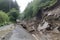 landslide blocking a road, forcing drivers to find alternative route
