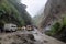 landslide blocking road, with rescue vehicles on the scene