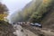 landslide blocking road, with rescue vehicles on the scene