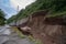 landslide that has buried a road, with only the tops of cars visible