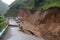 landslide that has buried a road, with only the tops of cars visible