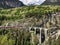 Landwasser viaduct in the Davos mountains near Filisur. Beautiful old stone bridge with a moving train. Spring Time