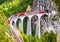 Landwasser Viaduct in Filisur, Switzerland. It is landmark of Swiss Alps. Bernina Express train on railroad bridge in mountains.