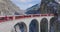 Landwasser Viaduct with Glacier and Bernina express in switzerland snow winter.