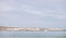 Langebaan Lagoon, South Africa. A Beautiful tourist destination with rocky coastline with seagulls and sail boat in the background