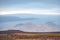 Langjokull Glacier view over bald rock and grass land towards the white ice giant