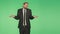 Language of the body. man in suit, green background. gesture to shrug. hromakey