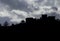 Lanhoso Castle silhouette against the sunlight with a blue and cloudy sky in Povoa de Lanhoso.