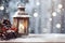 Lantern with burning candle, pine cones and red baubles on wooden board surface.