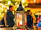 Lantern with candle inside of it pictured in the middle of the Christmas market in winter Riga in Latvia