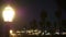 Lantern glows on beach after sunset, California coast, USA. Beachfront boardwalk