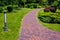 Lantern iron ground garden lighting of a park path paved with stone tiles.