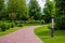 Lantern iron ground garden lighting of a park path paved with stone tiles.