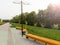 Lantern and park bench. Camping. A beautiful place in the city. A bench stands near green trees. Lantern for street lighting.