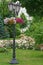 Lantern in the summer garden decorated with flowers