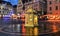 Lantern with yellow candle blurred  light on wooden top night street  restaurant medieval houses people walk in Tallinn Old Town