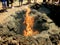 Lanzarote island Spain fire coming out of a small crater in volcanic terrain, from which tourist visits are made and barbecues are