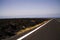 Lanzarote - Timanfaya NP: Driving trip on endless empty asphalt road between black lava rocks in barren landscape
