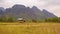 Laos. Empty rice field with straw on a background of mountains