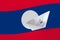 Laos flag depicted on paper origami ship closeup. Handmade arts concept