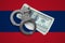 Laos flag with handcuffs and a bundle of dollars. Currency corruption in the country. Financial crimes