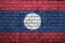 Laos flag is painted onto an old brick wall