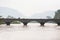 Laos man riding motorcycle crossing the bridge across Mekong River. The Mekong River is going overflow. Don Det Island, Si Phan