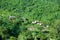 Laos, Mekong river side. Small houses in green forest