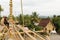 Laos: A men is doing roof repair at Wat Xieng Thong temple in Luang Brabang City