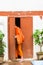 Laotian monk enters the building in Louangphabang, Laos. Copy space for text. Vertical.
