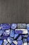 Lapis lazuli heap stones texture on half black stone background. Place for text