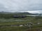 Lapland landscape at Virihaure lake with sami village Staloluokta houses and cottage, snow capped mountains and birch