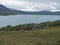 Lapland landscape at Virihaure lake with sami village Staloluokta houses and cottage, snow capped mountains and birch