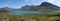 Lapland nature landscape wide panorama of blue glacial lake Allesjok near Alesjaure, birch tree forest, snow capped mountains.