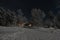 Lappish moonlit winter landscape, welcoming lights from the Hotel at the side of the frozen lake