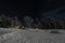 Lappish moonlit winter landscape, welcoming lights from the Hotel at the side of the frozen lake