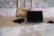 Laptop and black headphones lies on a large bed in a scandinavian style, the concept of sweet home, cozy mood, work at home,