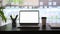 Laptop with blank screen, pencil holder, coffee cup and books on black wooden table.