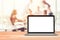 Laptop with blank screen placed on wooden table Blurred people meeting background ,Startup Business plan and discussing