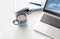 Laptop, calendar and a blue cup of coffee on a bright desk, copy