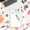 Laptop, clipboard, flowers, cosmetics and accessories on white background. Flat lay. Top view. Feminine freelancer composition